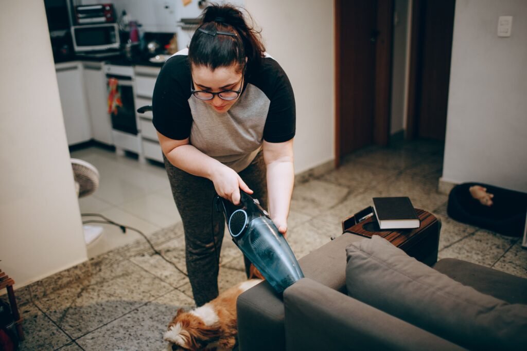 Vacuuming upholstery to remove dog hair